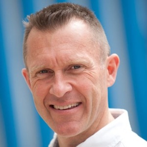 A confident man with a friendly smile, showcasing positivity and approachability.