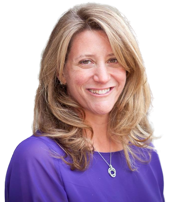 A smiling woman with long wavy hair wearing a purple blouse and a necklace.